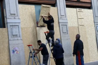 Reuters A group of workers boarding up windows in Lyon