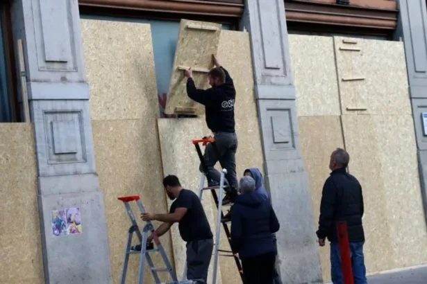 Reuters A group of workers boarding up windows in Lyon