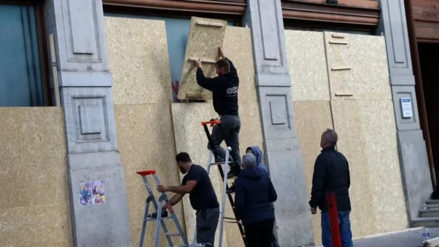 Reuters A group of workers boarding up windows in Lyon