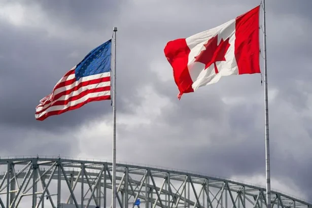 Getty Images The US and Canada flags flutter next to the Blue Water Bridge border crossing in Point Edward, Ontario, on 24 October 2025.