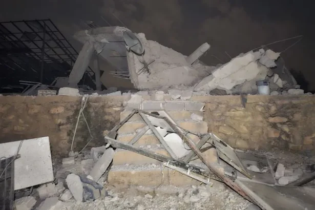 Anadolu via Getty Images Rubble sits atop a small brick wall and six stairs.