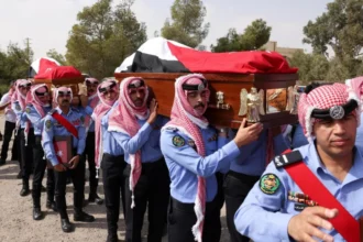 Reuters Jordanian security personnel carry the coffins of victims of a church shooting in Karak, Jordan (25 October 2026)