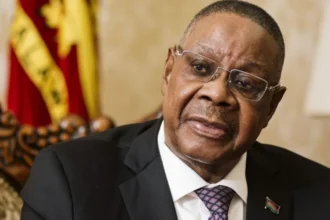 Bloomberg via Getty Images Peter Mutharika wearing a black suit and dotted tie speaks during an interview in Lilongwe, Malawi